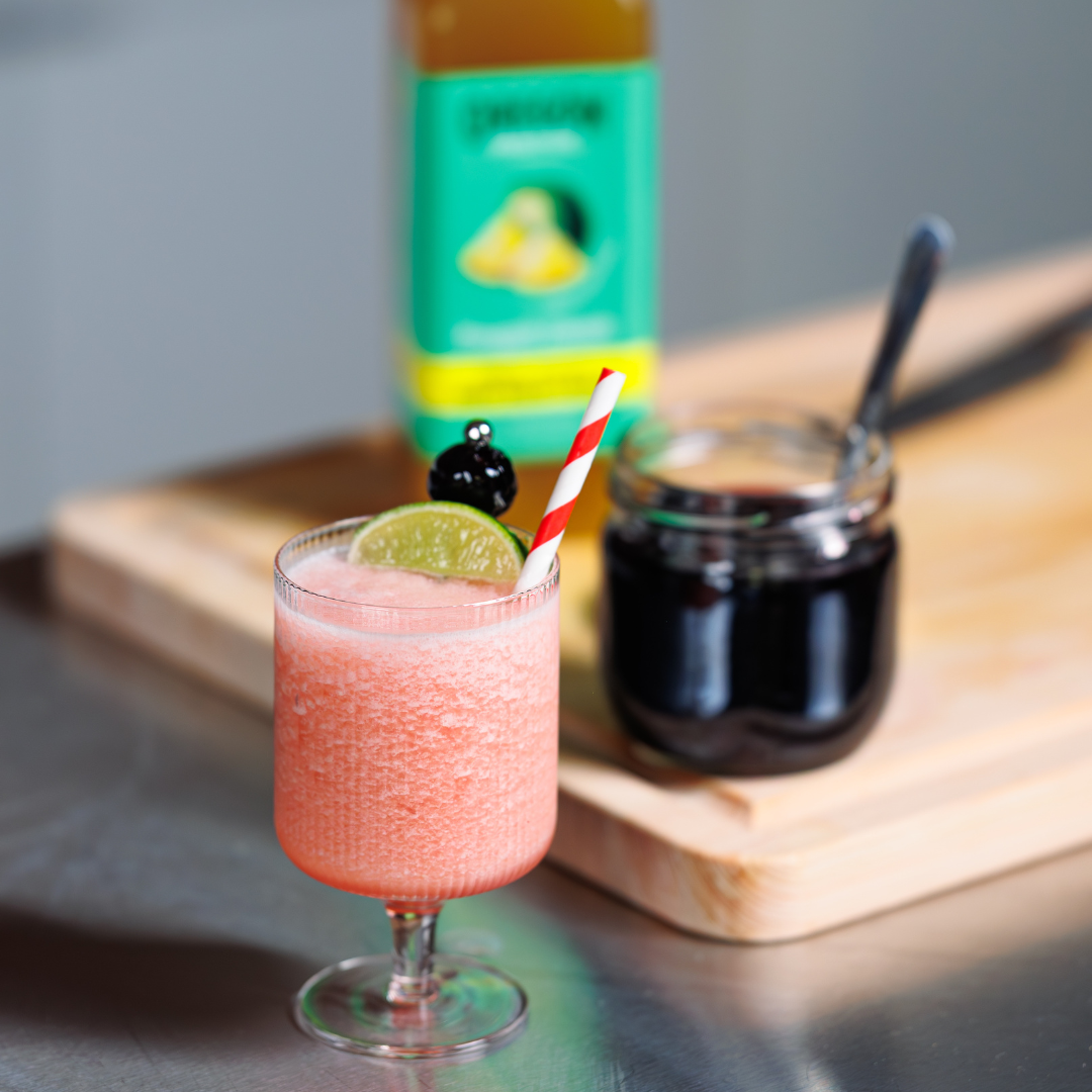 Icy pink beverage with cherry garnish