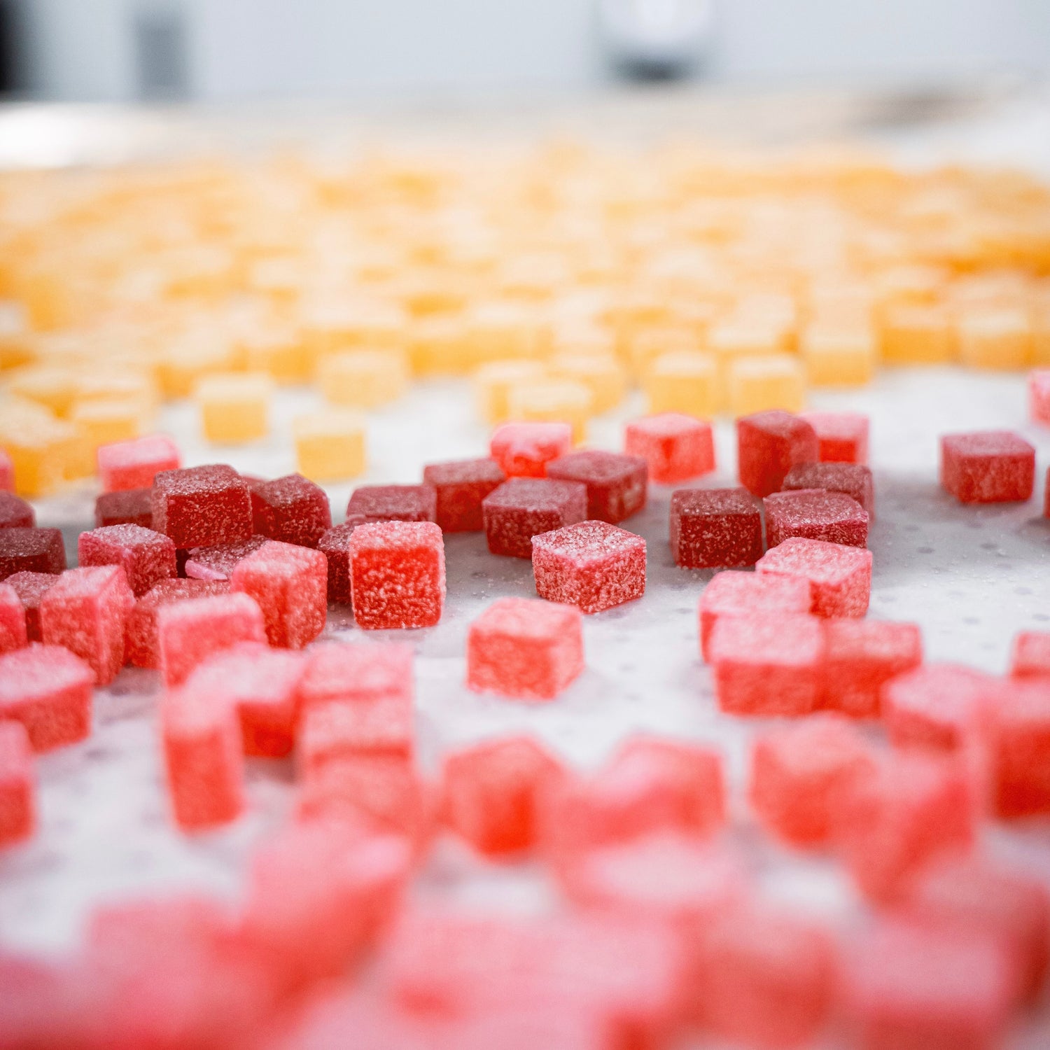 Red and yellow fruit gummies on a tray