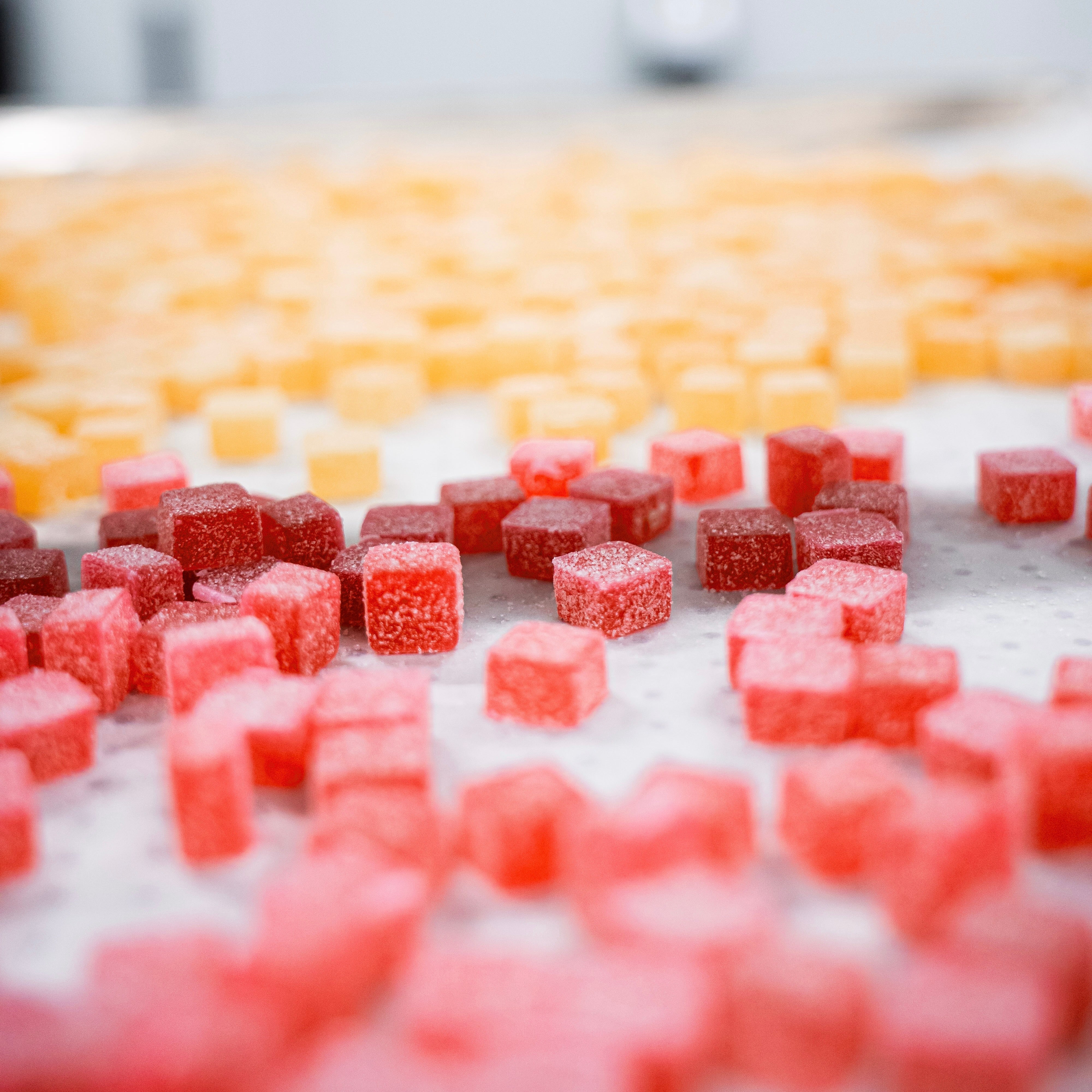 Red and yellow fruit gummies on a tray