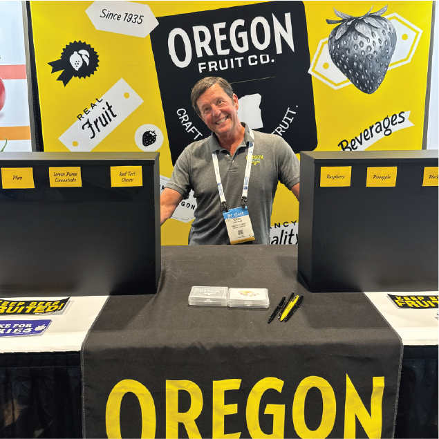 Man behind Oregon Fruit Company booth at trade show