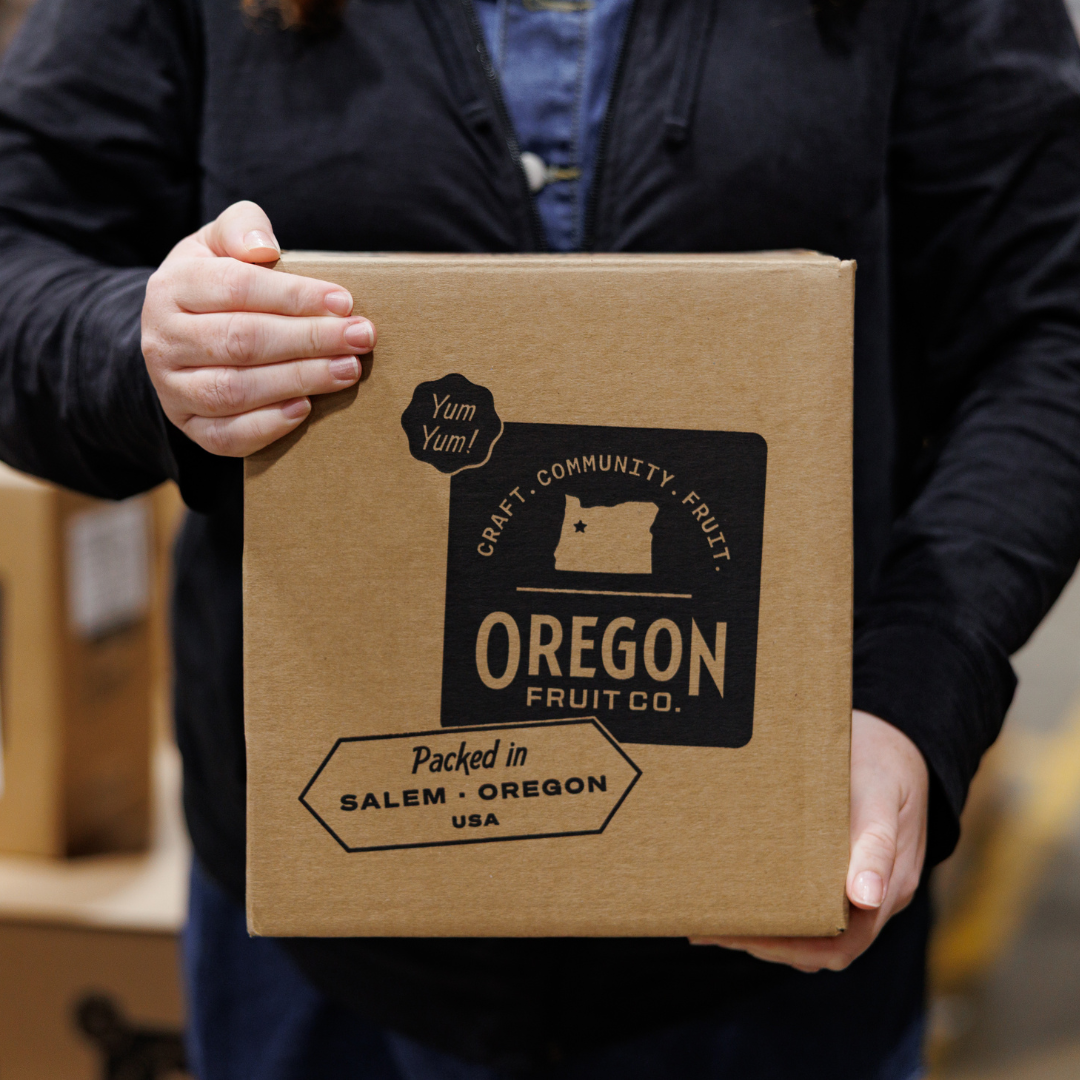 person holding a box of aseptic fruit puree