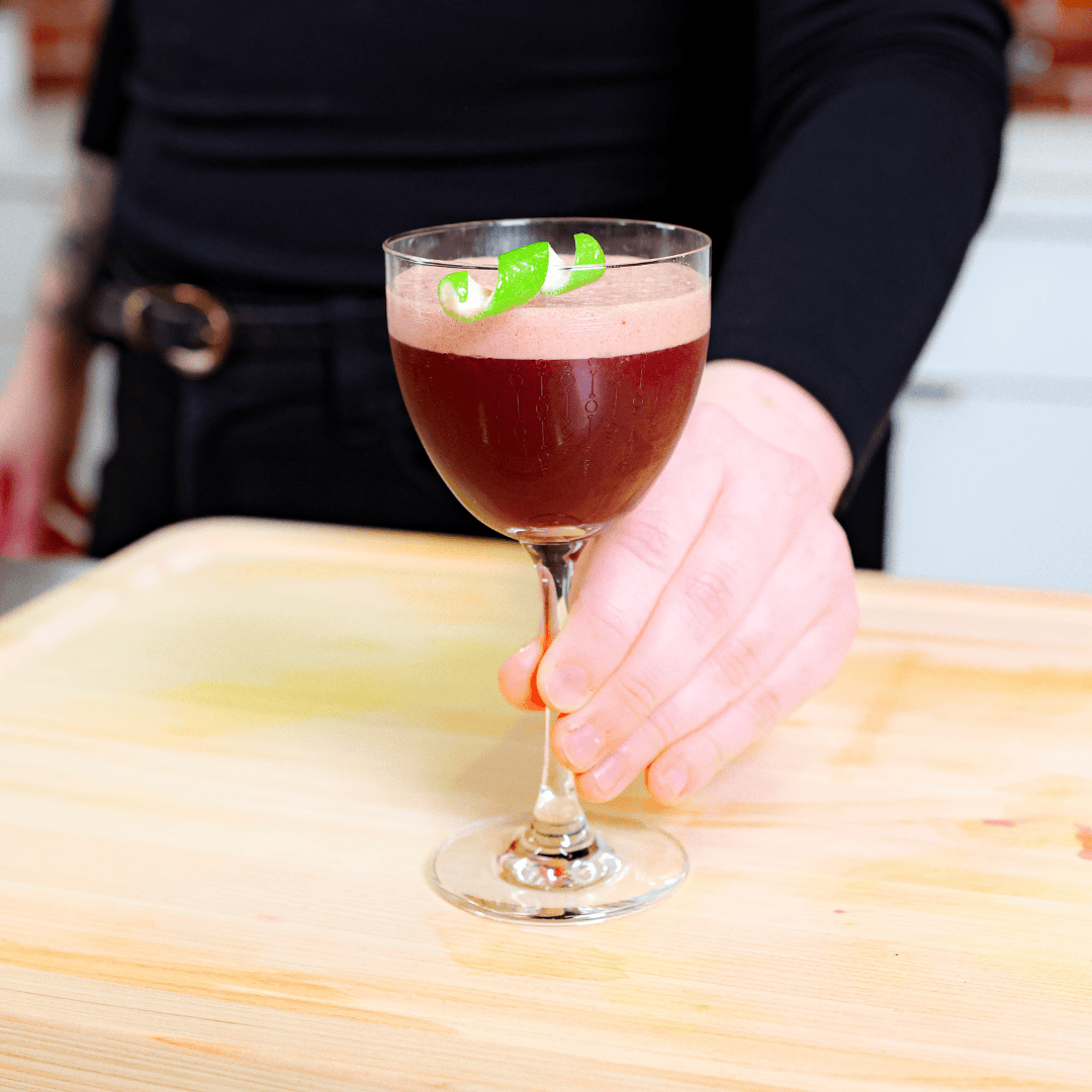 a raspberry colored coldbrew drink in a cocktail glass
