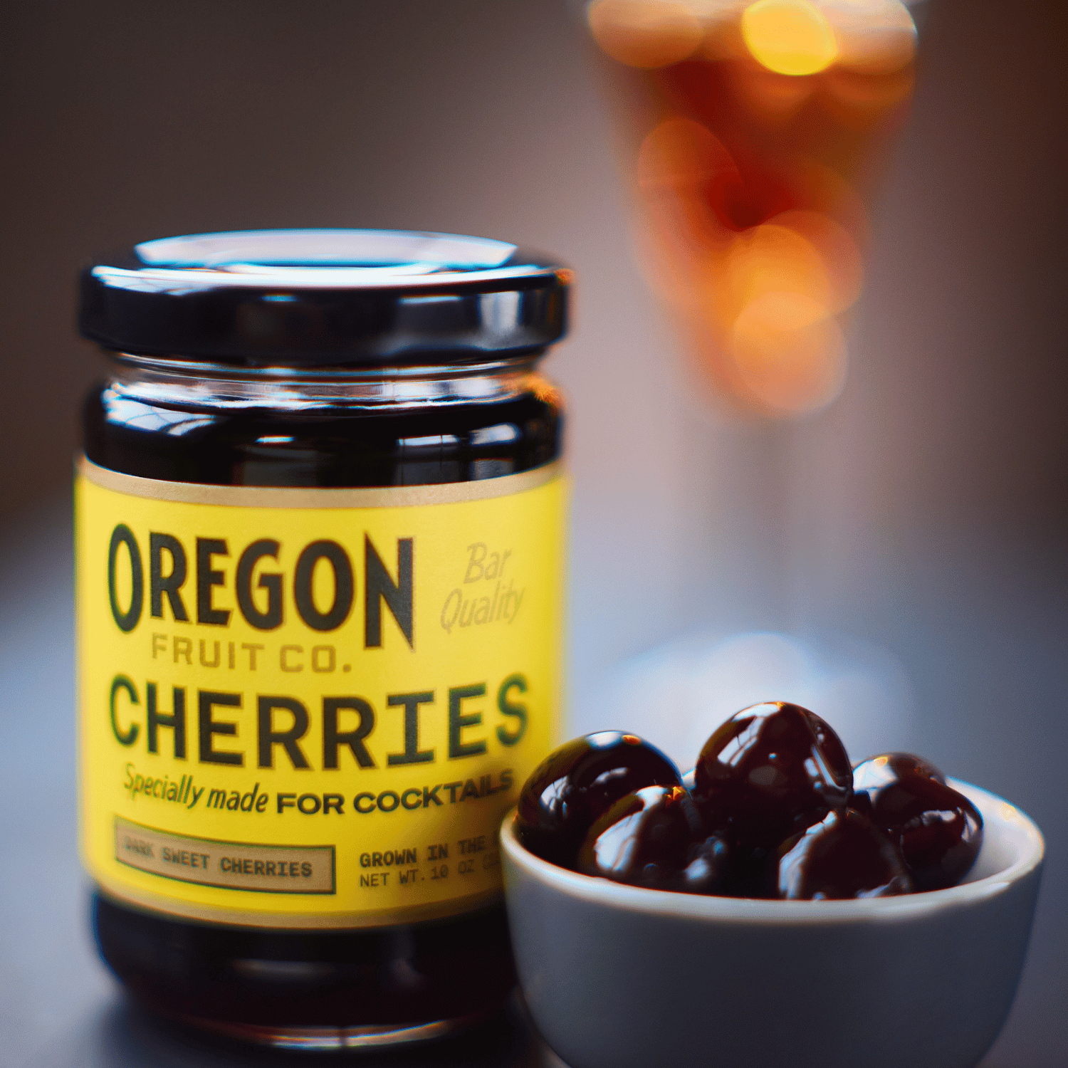 jar of oregon fruit cocktail cherries next to bowl of cherries