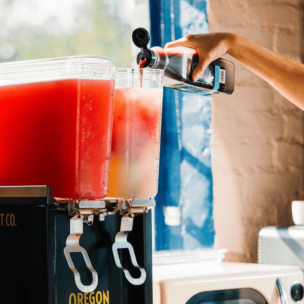 Pouring Oregon Fruit Pourable Fruit into a fruit drink