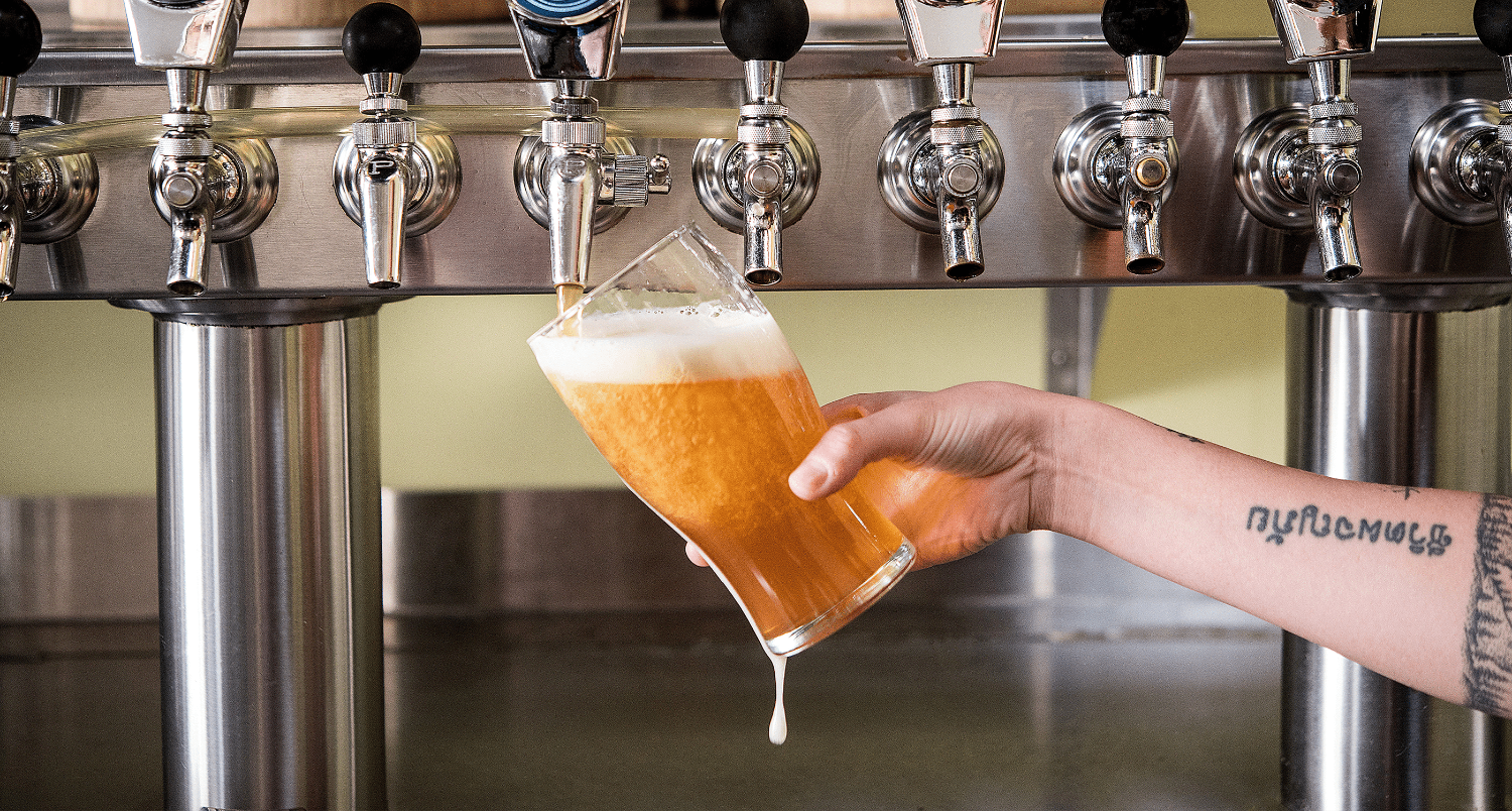 Beer being poured into a glass from a tap