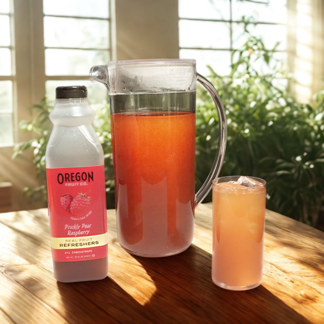 Glass pitcher of refresher tea next to glass of iced drink