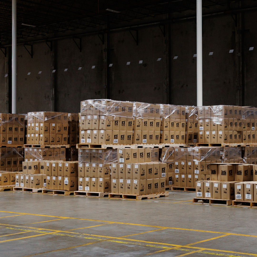 Boxes of aseptic puree are stacked on pallets in a warehouse