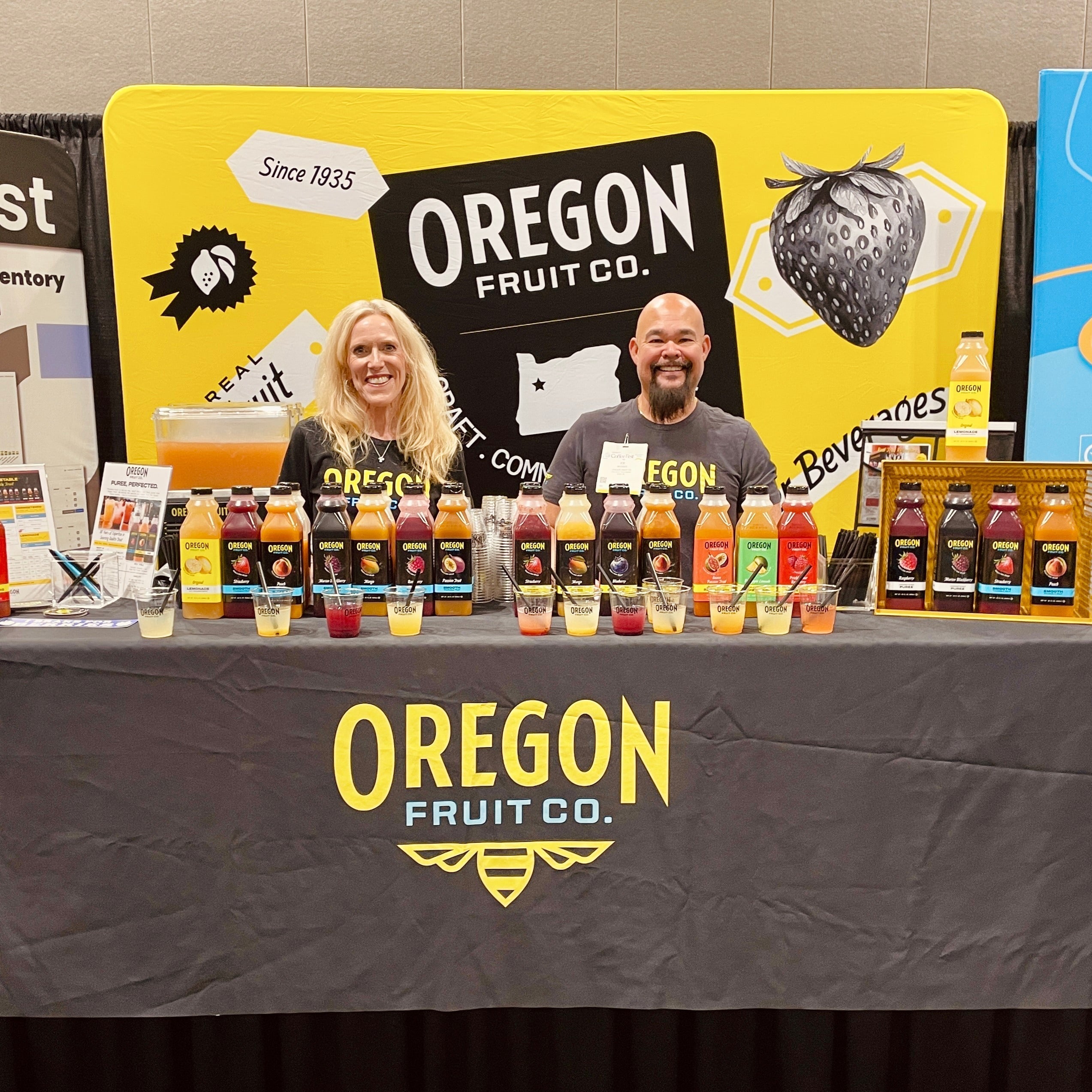 Two Oregon Fruit employees show off our products at our booth
