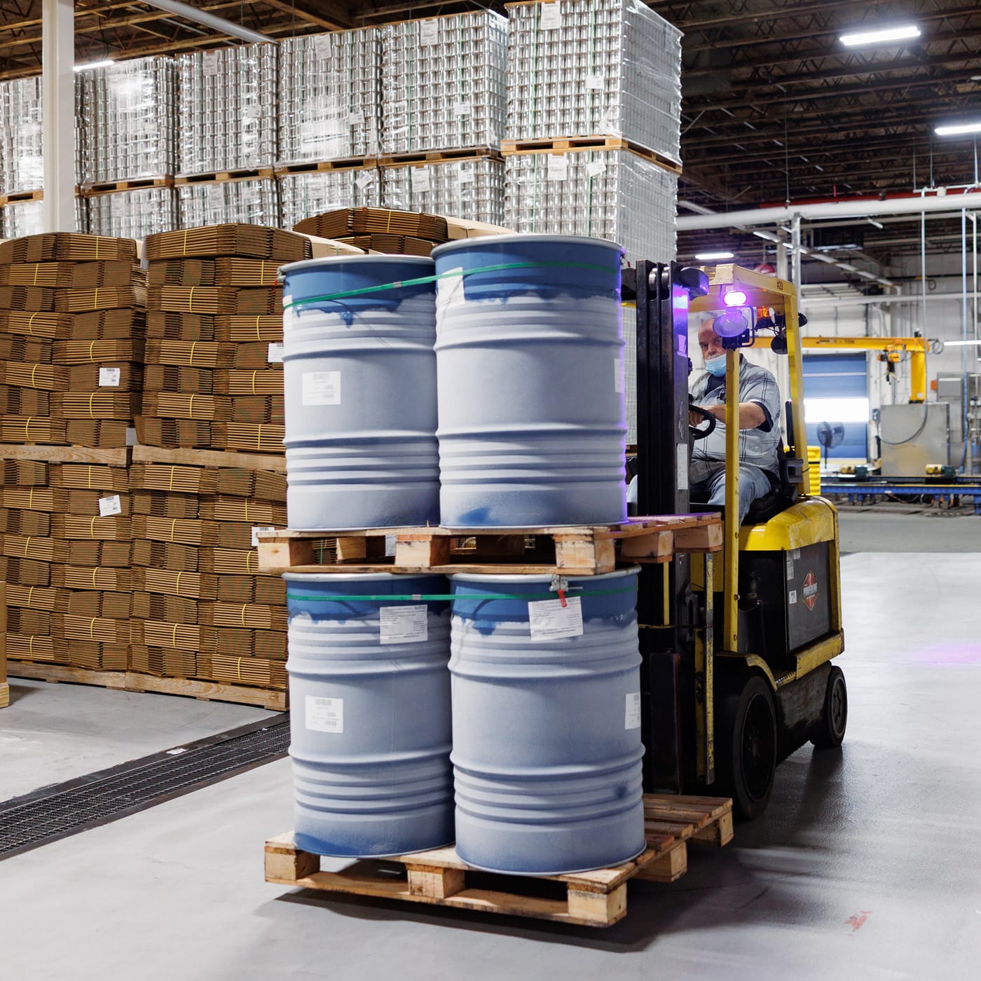 Worker at the Oregon Fruit Plant moving barrels on a forklift  